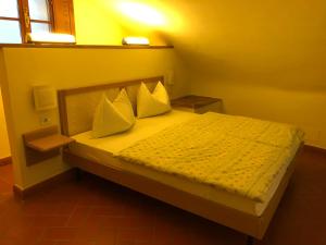 a bedroom with a bed with two pillows at Hapimag Resort Tonda in Montaione +38 photos