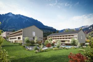 una representación de un hotel con montañas en el fondo en Hotel die Wälderin-Wellness, Sport & Natur, en Mellau