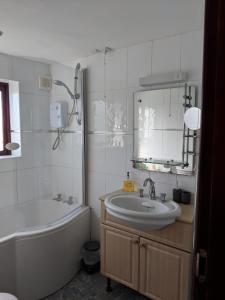 a bathroom with a tub and a sink and a bath tub at Princes Lodge in Telford