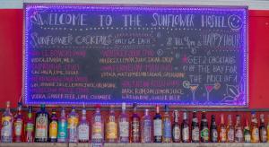 a chalkboard with a bunch of bottles of alcohol at Sunflower Hostel Berlin in Berlin