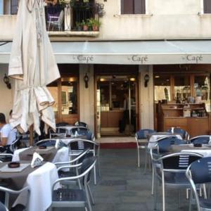 a restaurant with tables and chairs and an umbrella at Ca' Frezzeria in Venice