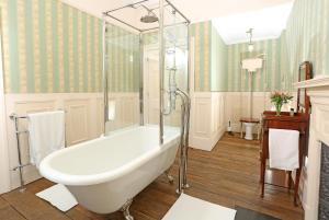 a bathroom with a tub and a shower at Llangattock Park House in Crickhowell +127 photos
