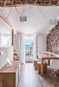 a living room with a table and a view of the ocean at La Vista di Marina by The First in Riomaggiore