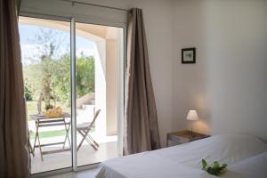 a bedroom with a bed and a balcony with a table at Vinaigrier Hills VI3086 by Riviera Holiday Homes in Nice +45 photos