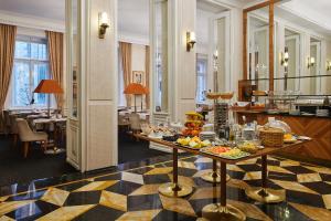 a hotel lobby with a buffet of food on a table at Ventana Hotel Prague in Prague