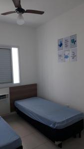Uma cama ou camas num quarto em Apartamento na Praia Grande - Ubatuba