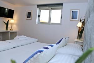 Łóżko lub łóżka w pokoju w obiekcie Hotel Delfin