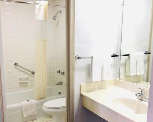 a bathroom with a toilet and a sink and a tub at Motel 6-Falls Church, VA - Arlington Boulevard in Falls Church