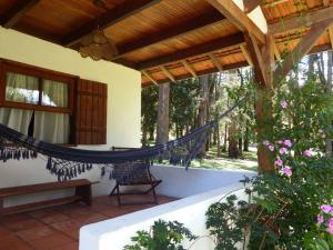 a hammock on the porch of a house at Hotel Refazenda in Visconde De Maua