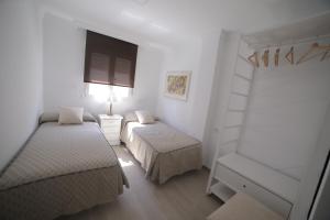 niewielka sypialnia z 2 łóżkami i drabiną w obiekcie APARTAMENTO RIALTO 2 w Maladze