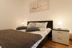 a bedroom with a bed with two pillows on it at Luxury Villa Nada with Pool in Petrcane +37 photos
