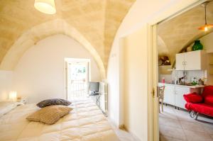 a bedroom with a large bed and a red couch at Casa Del Sole in Matera