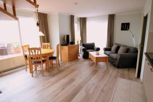 a living room with a couch and a table at Penthouse am Großen Plöner See in Ascheberg