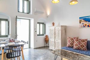 a living room with a couch and a table at Astrea Suites Feggaropetra Cave House in Fira