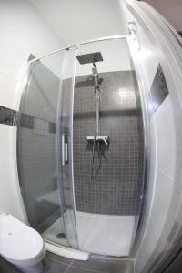 a bathroom with a shower and a toilet at La casa di Luce in Reggio Calabria