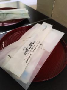 a red plate with a package on top of it at De UPTOWN Hotel @ Damansara Uptown in Petaling Jaya