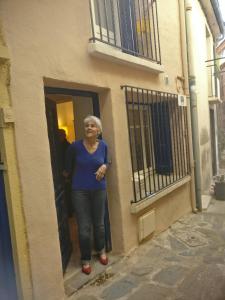 a woman standing in the doorway of a building at 3 Rue Marceau in Collioure