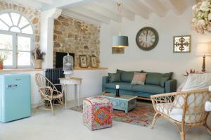 a living room with a blue couch and chairs at Villa Inocencia in Santillana del Mar