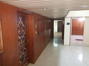 a hallway with wood paneling and a hallway with a door at Hostel Vienna in Cairo