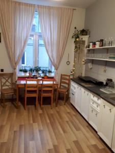 a kitchen with a table and chairs and a kitchen with a window at Stacja Centrum in Częstochowa