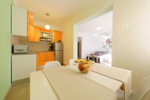 a kitchen with a table with a bowl of fruit on it at Luxury Villa Nada with Pool in Petrcane
