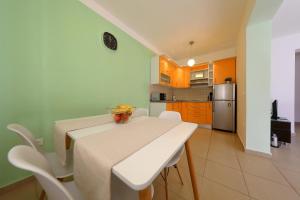 a kitchen and dining room with a table and chairs at Luxury Villa Nada with Pool in Petrcane