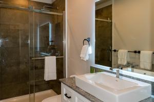 a bathroom with a sink and a shower at Lake Placid Inn: Main Street in Lake Placid