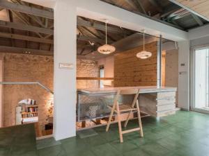 a dining room with a table and a chair at The Architect's House in Neo Chorio in Néon Khoríon