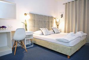 Łóżko lub łóżka w pokoju w obiekcie Hotel Delfin