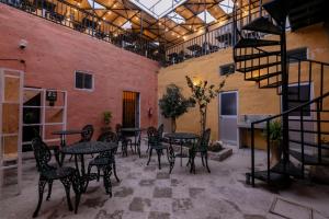 a patio with tables and chairs in a building at Way Kap Hostel Arequipa in Arequipa