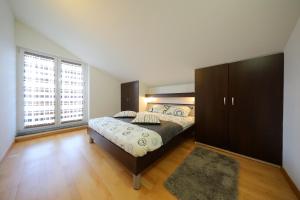 a bedroom with a large bed and a large window at Luxury Villa Nada with Pool in Petrcane