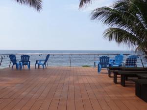 a group of chairs and tables on a deck overlooking the ocean at Resort Playa Azul in Tonsupa