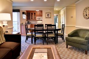 a living room with a table and chairs at Kingsmill Resort in Williamsburg