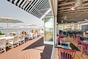 a restaurant with tables and chairs on a deck at Kingsmill Resort in Williamsburg