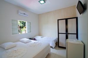 Кровать или кровати в номере Hotel Pousada Calliandra