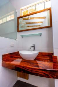 a bathroom with a wooden counter with a sink at Casa Killa Vichayito in Vichayito