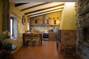 a kitchen with a table and chairs in a room at Quinta da Costeira in Sever do Vouga