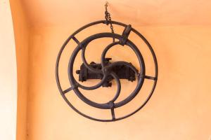 a black chandelier hanging on a wall at Hotel Cavalieri Del Mare in Marina di Massa +93 photos