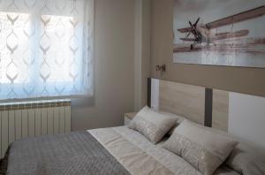 A bed or beds in a room at Alojamiento Turistico La Casa del tio Cesar