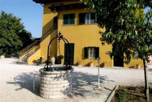 a building with a fountain in front of a building at Agriturismo La Cantina in Bastia Umbra