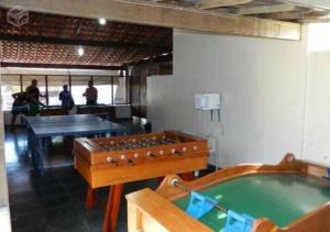 a room with a pool table and ping pong ball at Marina Clube in São Pedro da Aldeia