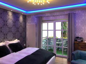 a bedroom with a bed with a blue led ceiling at City Luxus Appartement nähe Köln Messe - LANXESS Arena in Cologne