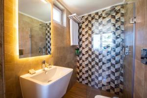 a bathroom with a sink and a shower at Kastro Apartments in Panormos Rethymno +87 photos