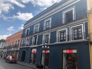 a blue building on the side of a street at Hotel Frida in Puebla