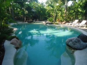 a large pool with blue water in a resort at Boutique Bungalows in Mission Beach