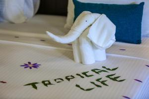 a stuffed elephant on a bed with the word transportation at Tropical Life Resort and Spa in Dambulla