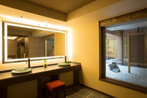 a bathroom with two sinks and a large mirror at Hotel Keihan Kyoto Grande in Kyoto