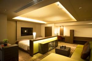 a hotel room with a bed and a television at Hotel Keihan Kyoto Grande in Kyoto