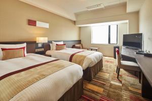 En eller flere senge i et værelse på Hotel Lumiere Grande Nagareyama-Otakanomori