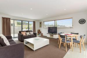 a living room with a couch and a table at 170 Hazards View Drive - Unit 2 in Coles Bay